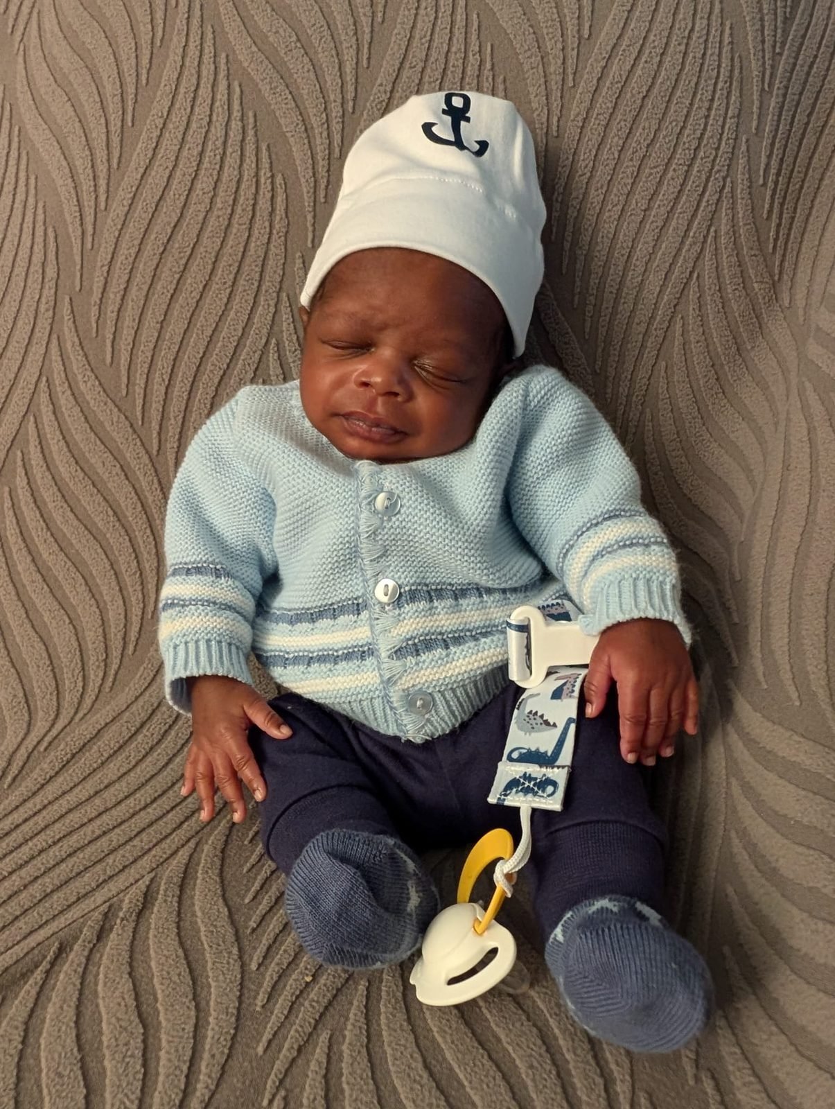 One of the Jakis triplets in a knitted cardigan
